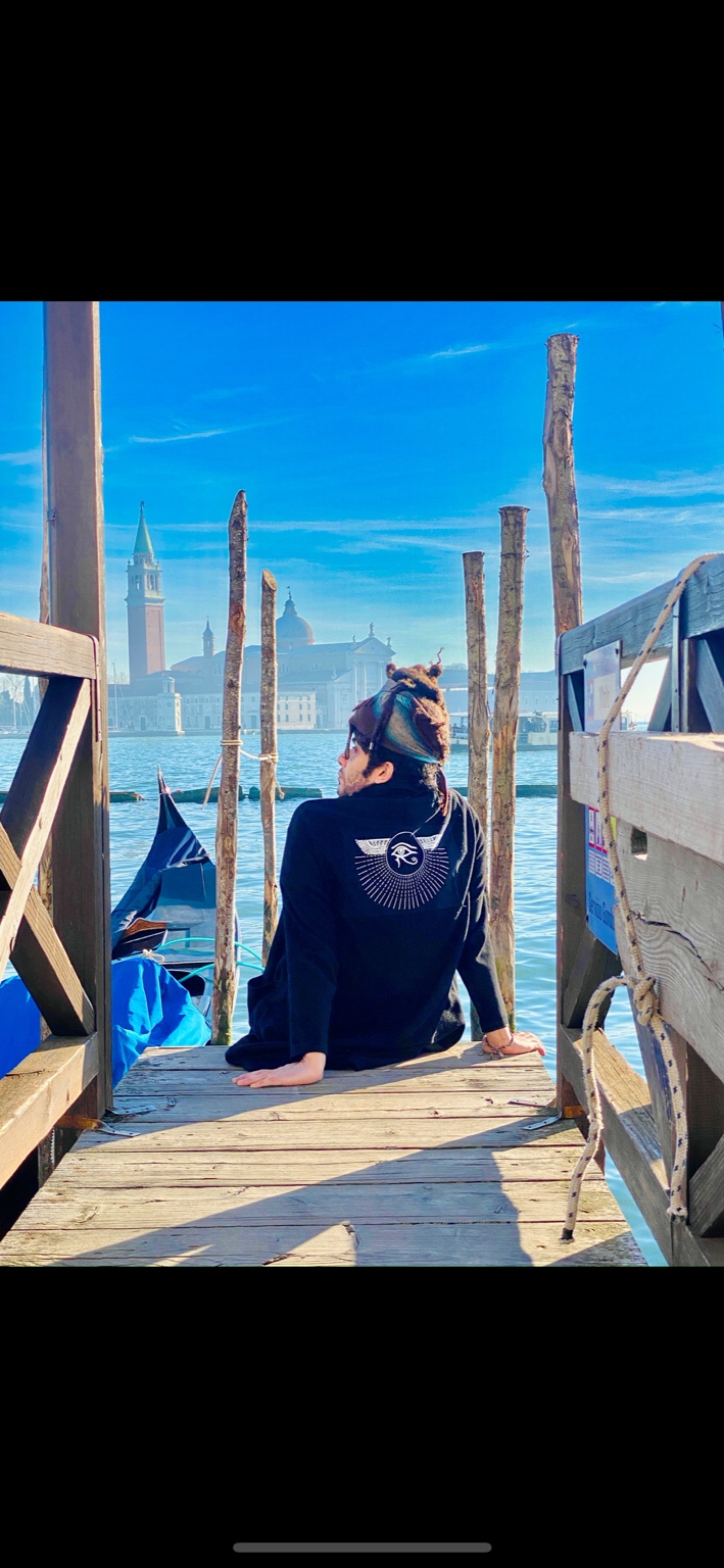 Sammer Salah sitting by the sea in Venice
